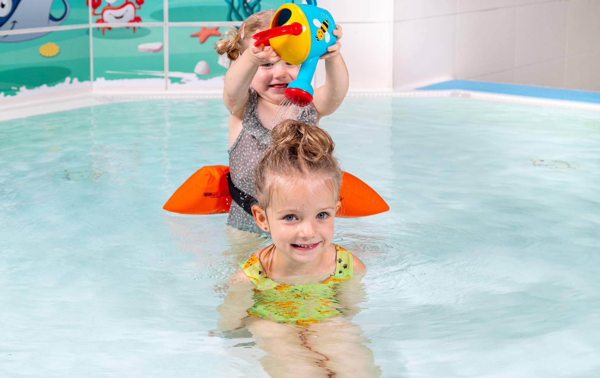 Zwei kleine Kinder im Kinderschwimmbecken